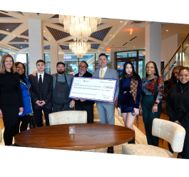Limani, AEF and school participants holding a large check 